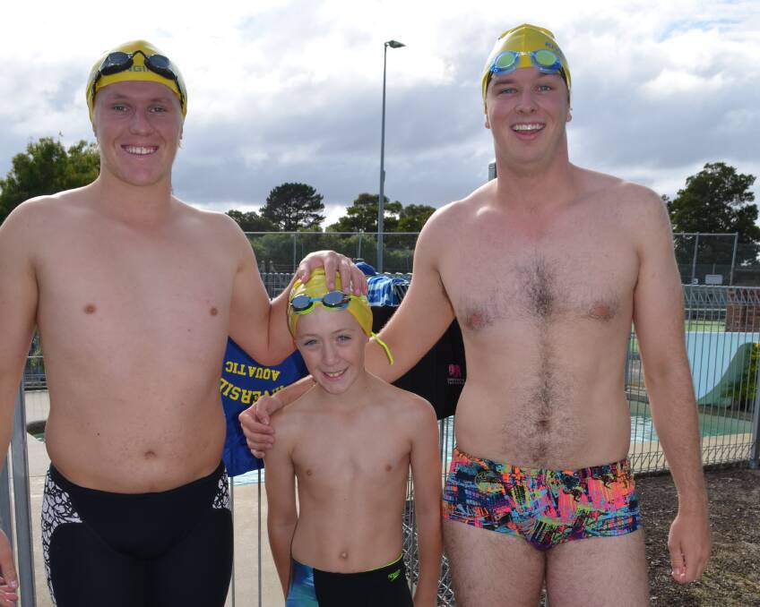 Addis Berry (centre), 10, of Riverside, prepares for the 66m open butterfly event against Marcus Darko (left) , 17, of Low Head,  and James Belstead, 20, of Launceston.