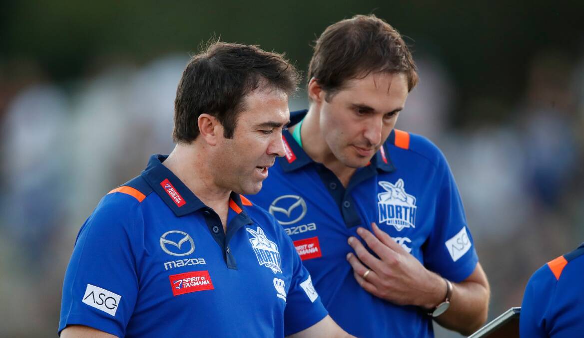 Brains trust: Former North Melbourne head coach Brad Scott chats to football general manager Cameron Joyce in 2018. Picture: AFL Media
