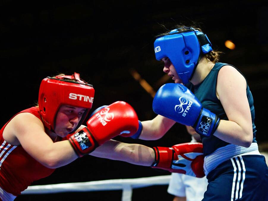 NW derby: Erika Creely (in red), of Ulverstone, and Madison Holland, of the Latrobe Boxing Club, contest a junior female 60kg event.