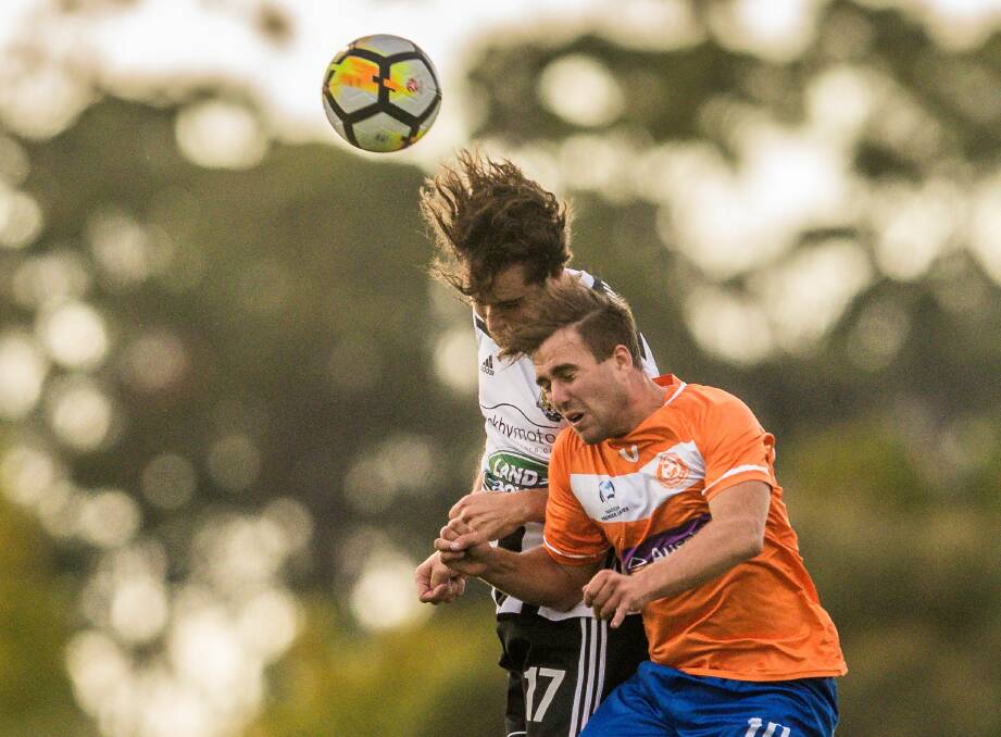 Head start: Launceston City's Rhys Goold and Riverside's Sam Davis challenge for a header in March during the sides' first statewide derby this century. Picture: Phillip Biggs
