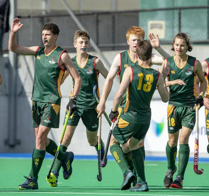 High fives: Tasmanian players celebrate a goal in the under-18 boys' hockey championships. Pictures: Click InFocus