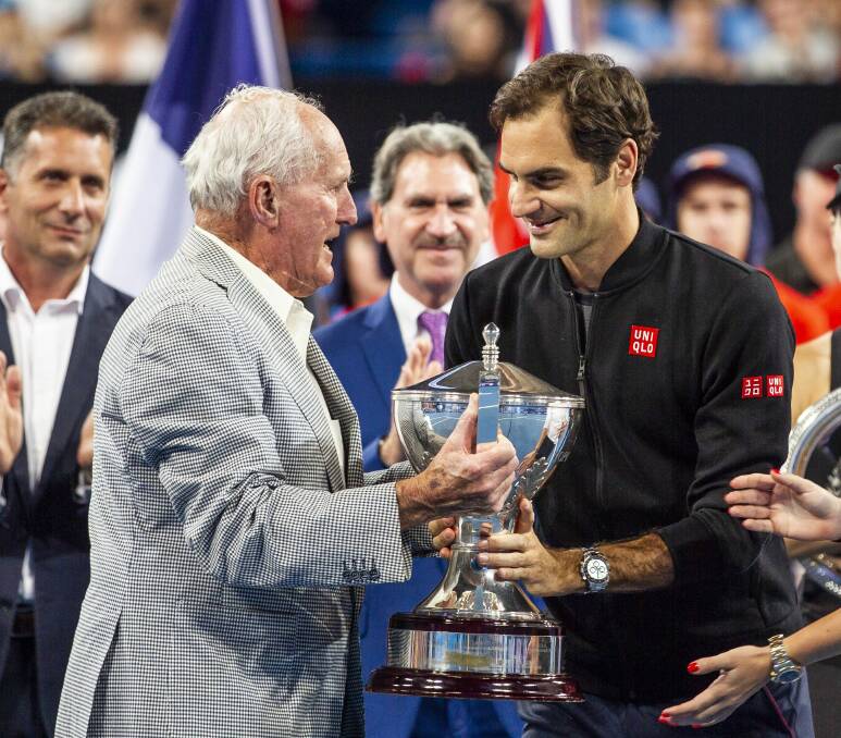 Cup tied: Neale Fraser presents the Hopman Cup to Roger Federer after Switzerland's victory in Perth in January. Picture: AAP