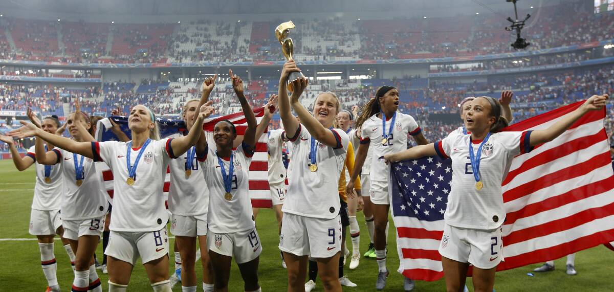 Making a statement: US players celebrate with the trophy after winning the Women's World Cup final against The Netherlands in Lyon, France. Picture: AP