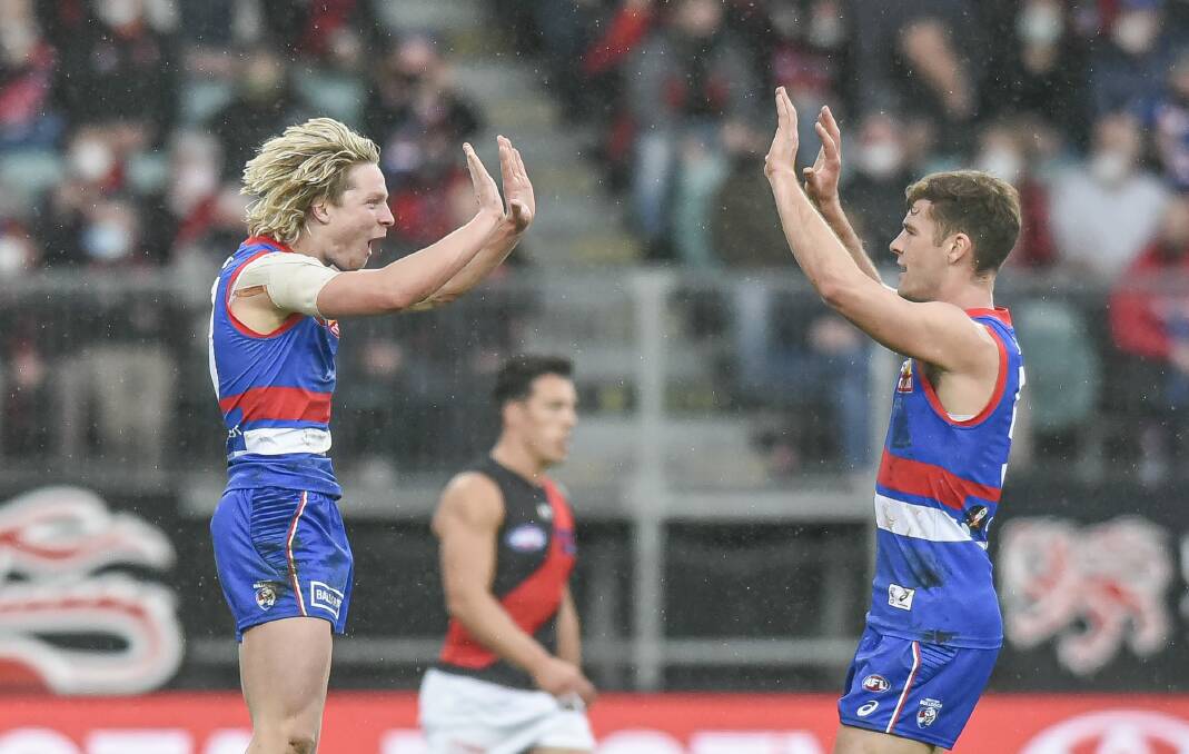 Flying high: Cody Weightman celebrates one of his four goals for Western Bulldogs against Essendon on Sunday. Pictures: Craig George