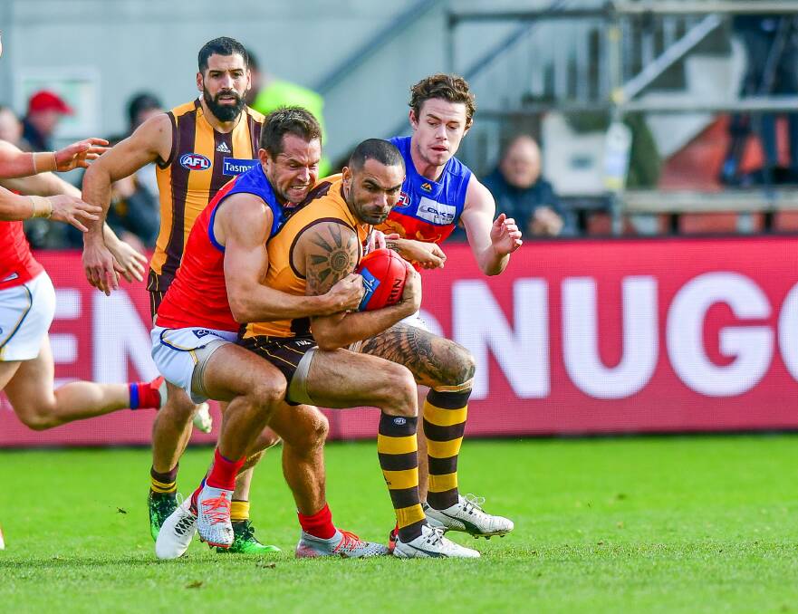 Luke Hodge and Shaun Burgoyne, playing against each other in Launceston in 2019. Picture by Scott Gelston
