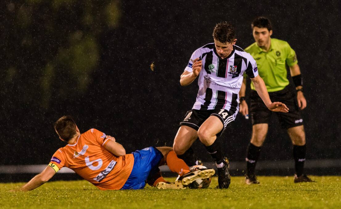Possession stat: Riverside captain Taylor Neilson and James Hawes, of Launceston City, get stuck in during the derby. Picture: Phillip Biggs