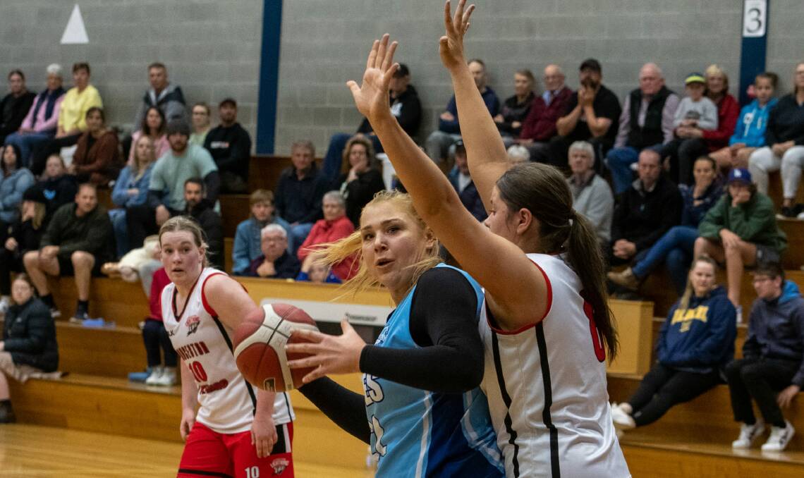On the ball: Launceston Lightning's Amber Brazendale blocks Penguin's Tayla Roberts at last week's State League basketball grand final in Launceston. Picture: Paul Scambler 