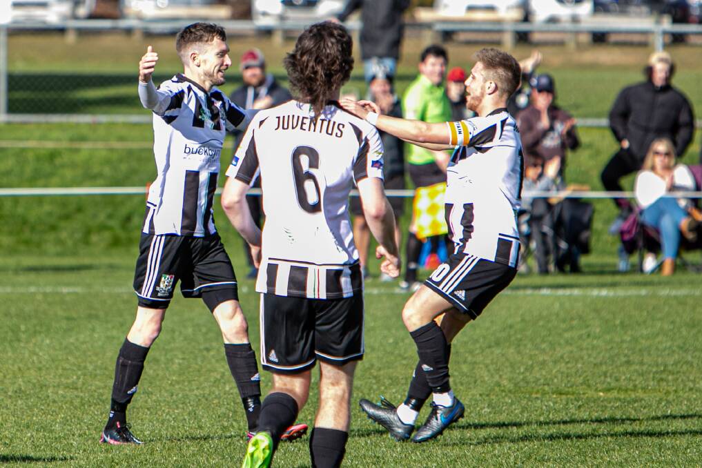 TON UP: Dan Smith celebrates his opening goal with captain Jarrod Linger in his 100th game. Pictures: Jamie Richardson