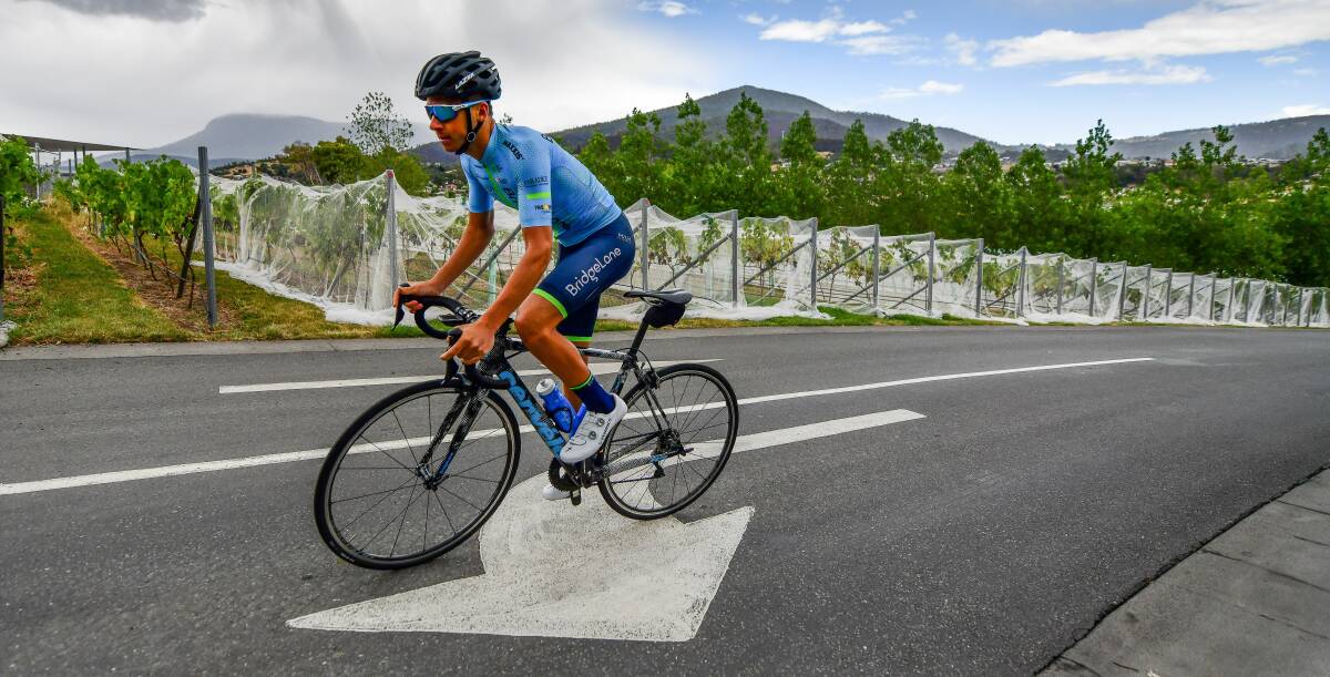 The way ahead: Tasmanian cyclist Scott Bowden follows the arrows while training near his home in Rosetta. Picture: Scott Gelston