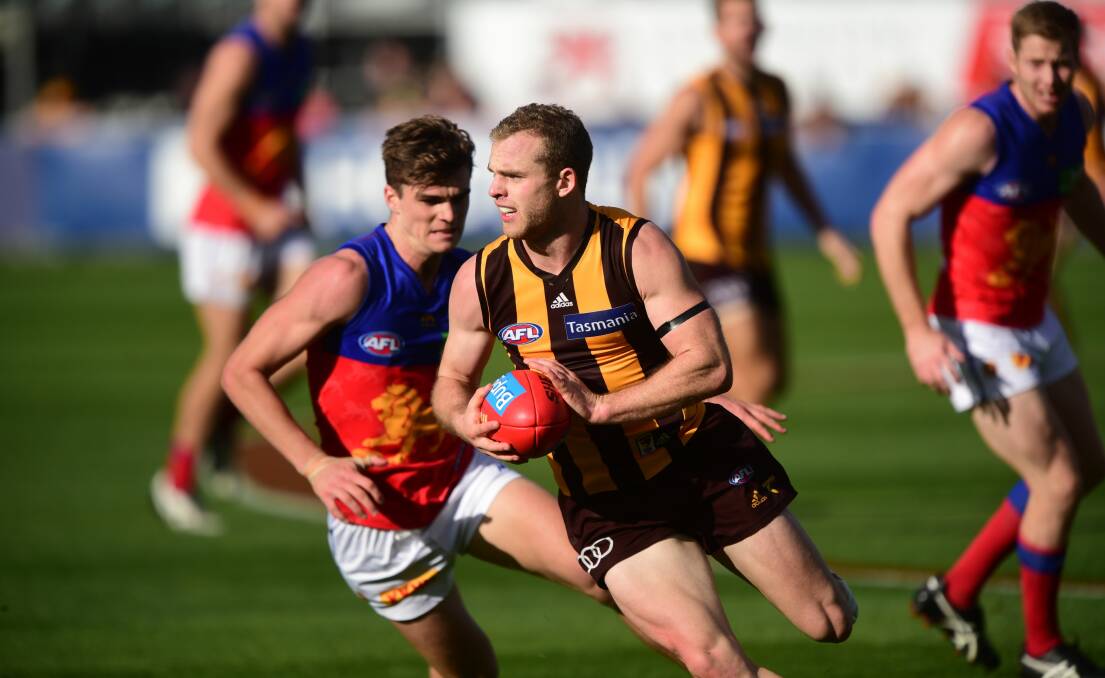 Can't catch me: Hawk ball magnet Tom Mitchell eludes Ben Keays.
