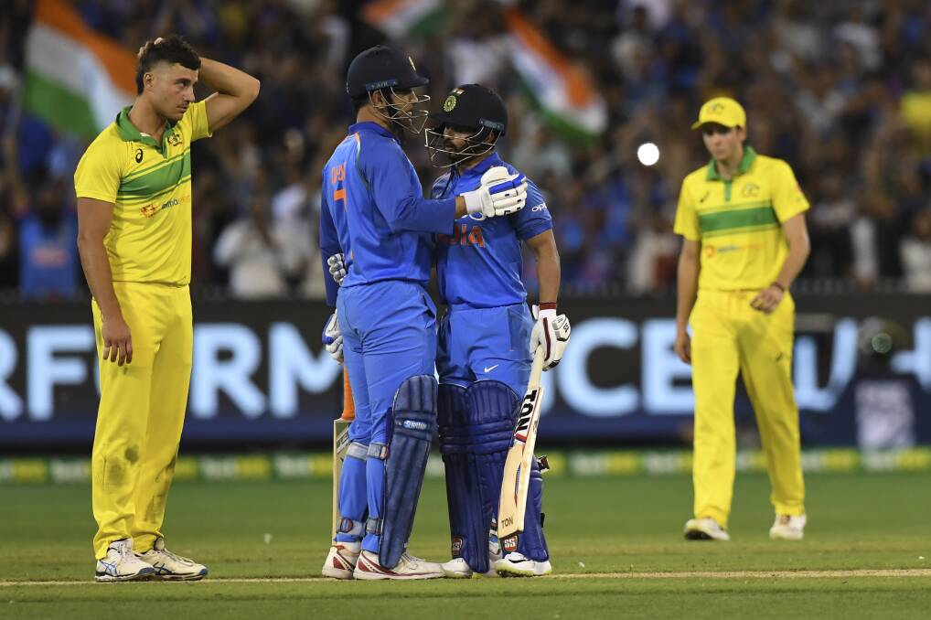 Indian summer: M.S. Dhoni and Kedar Jadhav celebrate India adding the one-day series to their breakthrough Test triumph over Australia. Picture: AP