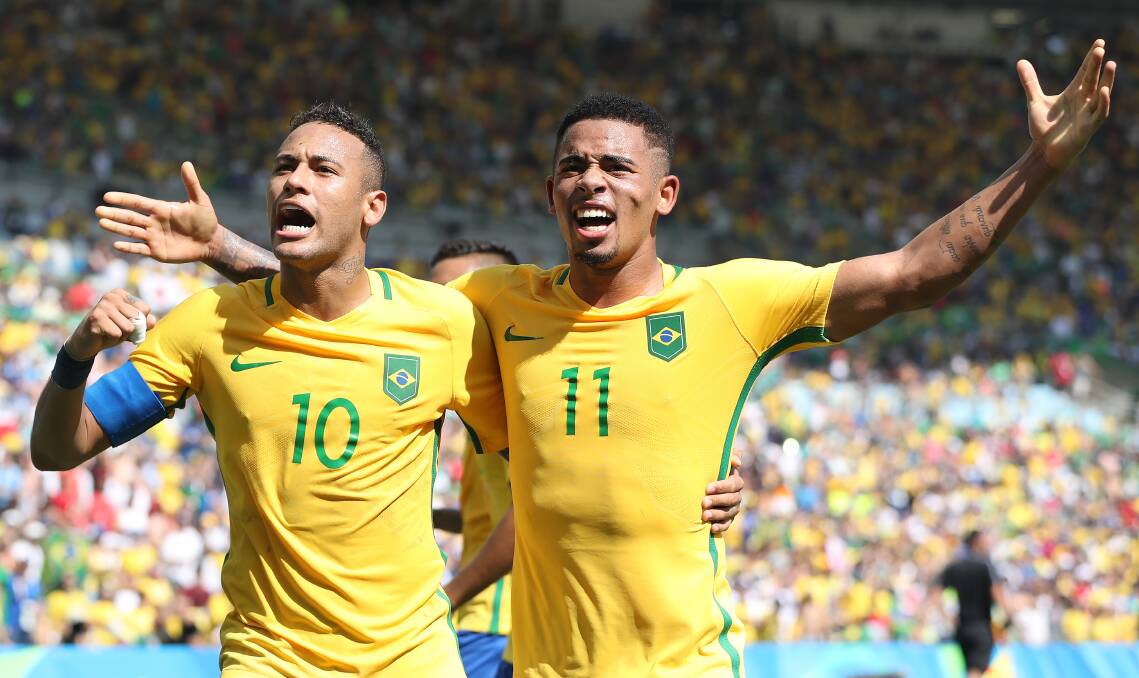 Golden guns: Neymar jumps in while Gabriel Jesus does his Christ the Redeemer impression during the Olympic Games semi-final between Brazil and Honduras at Maracana Stadium in Rio de Janeiro. Picture: Getty Images