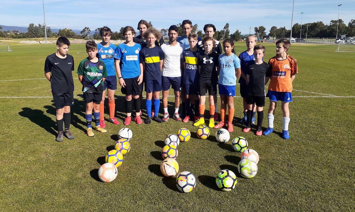 TOP 10: Luca Vigilante (centre) and his junior soccer players at Riverside Olympic pay tribute to Diego Maradona.