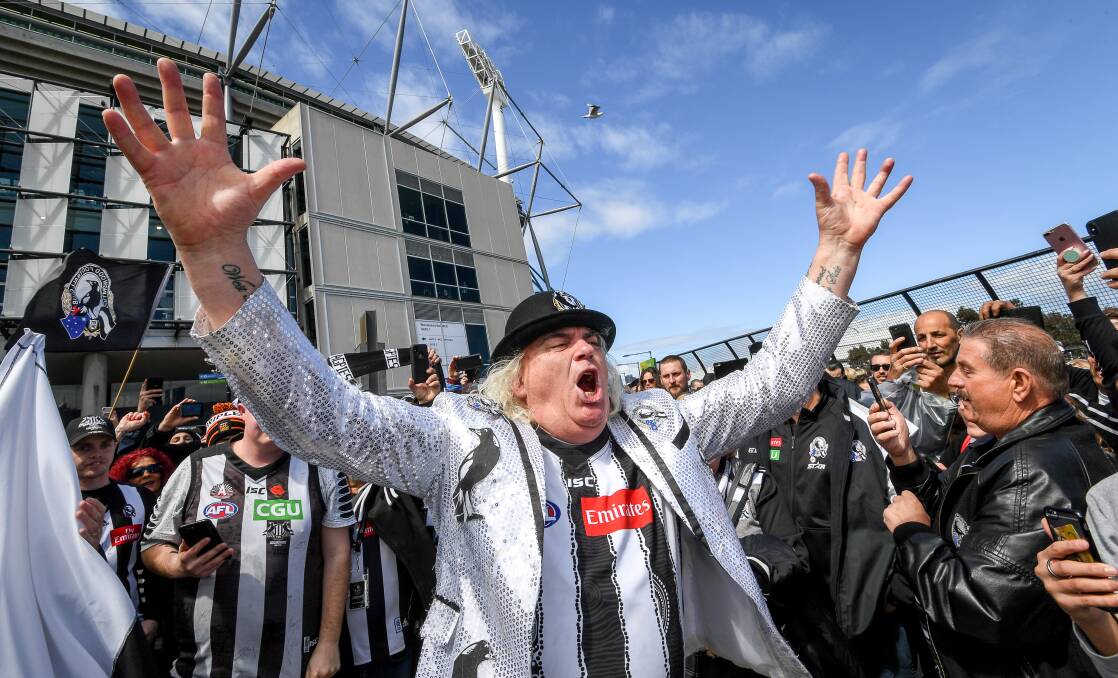 Pie in the sky: Cheer squad leader Joffa Corfe orchestrates a Collingwood song at the MCG. Picture: Justin McManus 