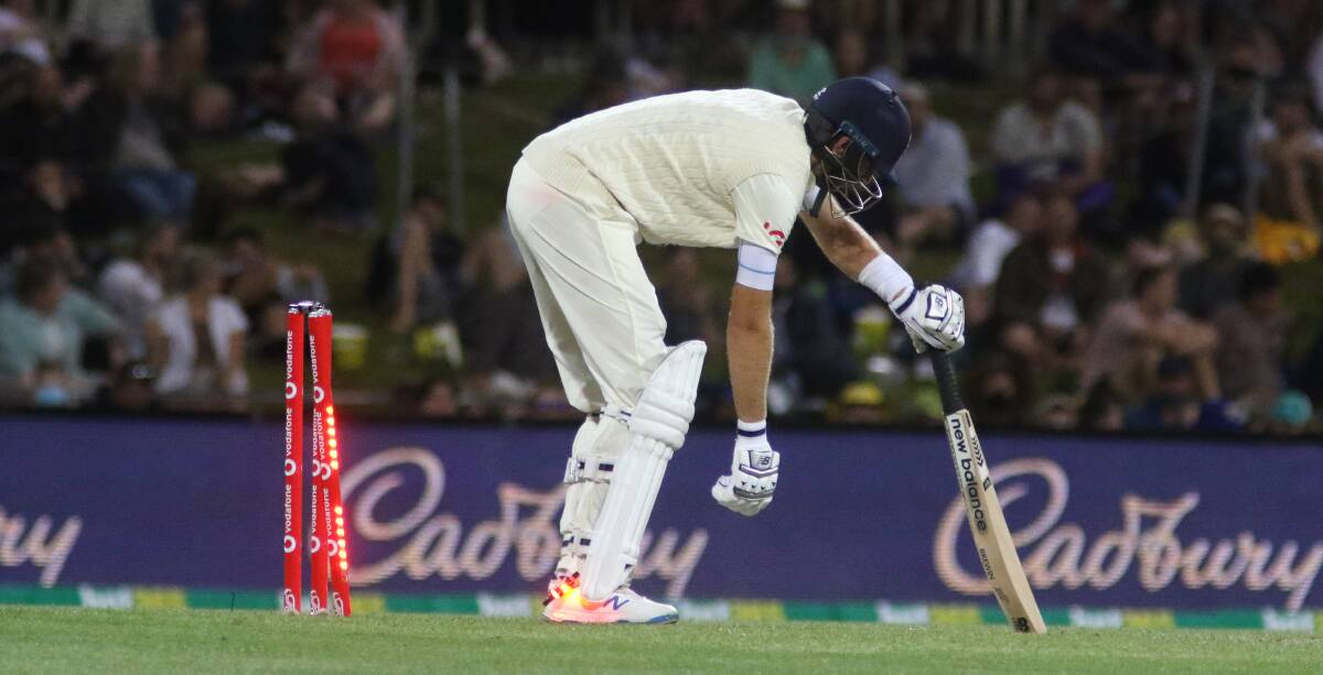 Seeing the light: Joe Root tests the batteries are still working in the Zinger bails.