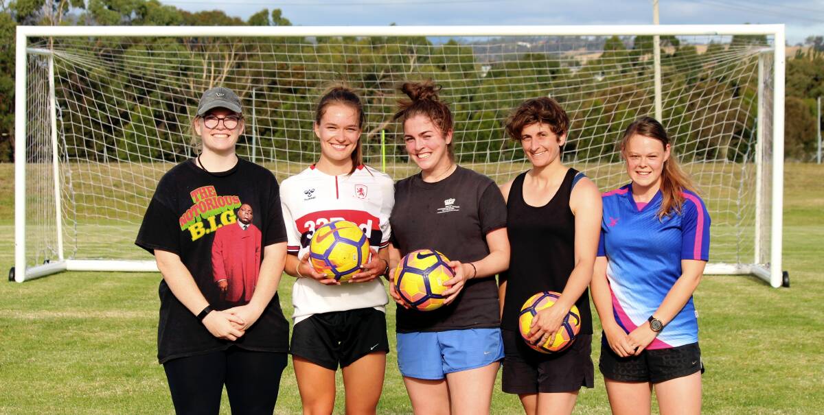 Under the bar: Annika Reitsema, Laura Dickinson, Imogen McCormick, Katie Hill and Nichola Clark take a break from Launceston United training. Picture: Hamish Geale 