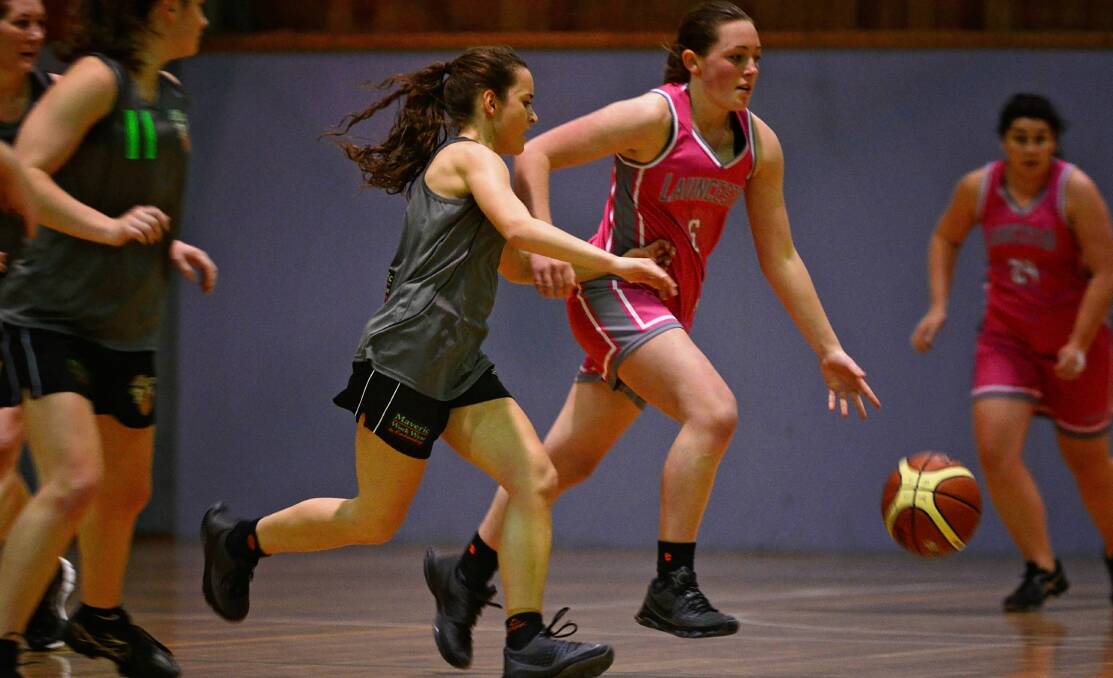 Challenge: Launceston's Sophie Ackerly and Paige French, of Maverics compete for possession.