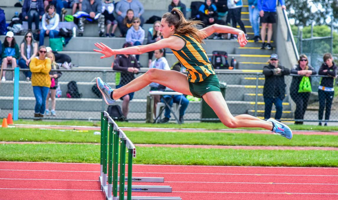 Leaps and bounds: Isabella Davie, of St Patricks College, competing in the under-16 hurdles at the Tasmanian All-Schools Athletics Championships at St Leonards. Picture: Neil Richardson