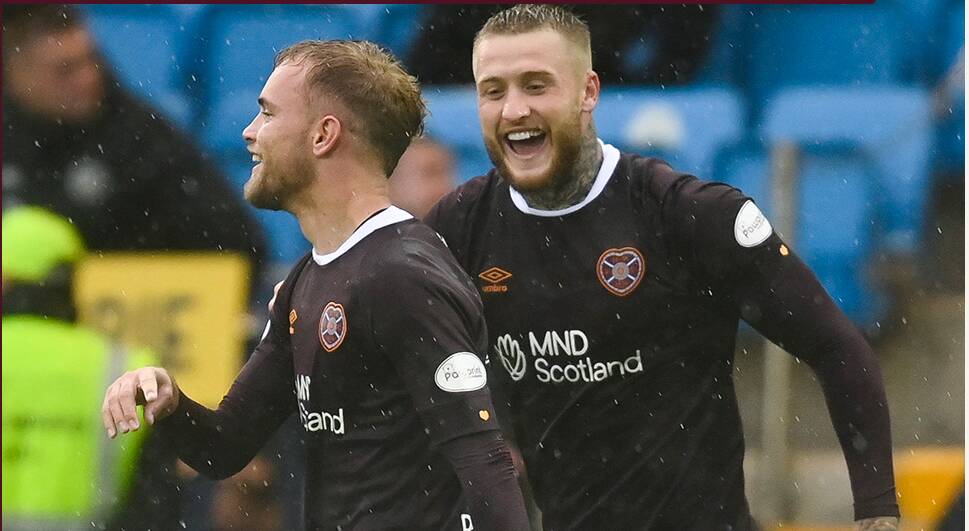 Hearts goal-scorers Nathaniel Atkinson and Stephen Humphrys celebrate their Scottish Premier League fightback on Sunday. Picture: Twitter 