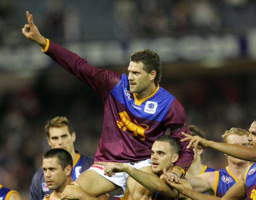 Lion heart: Brisbane players chair off Darryl White in his final game in 2005. Picture: The Age