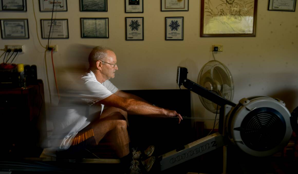 Pulling along: Tamar Rowing Club's Chris Symons with his ergo rowing machine and certificates for online activities. Picture: Scott Gelston