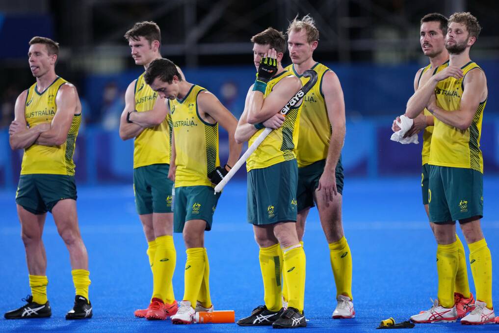 HEARTACHE: Eddie Ockenden (centre) and Josh Beltz (right) and their dejected Kookaburra teammates after losing the gold medal final in Tokyo. Picture: AAP