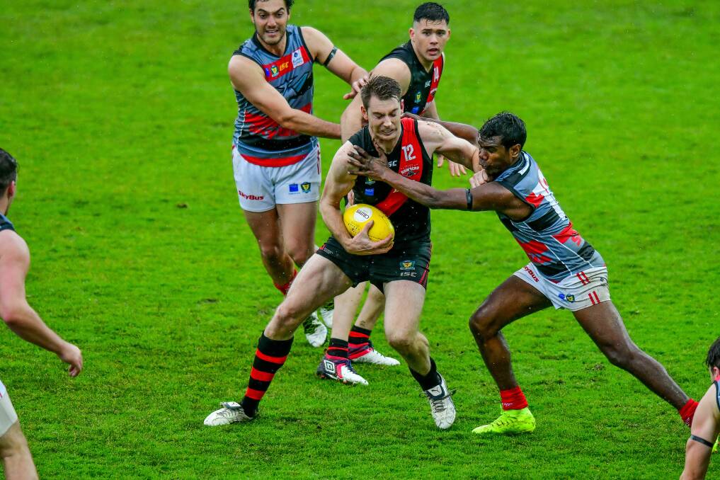 Under siege: Bart McCulloch is surrounded as North Launceston lost to Lauderdale in their TSL clash at UTAS Stadium. Picture: Scott Gelston