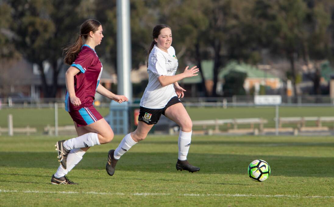 On the charge: Northern Ranger Josie Curtis chases Launceston City's Darcie Reilly. Picture: Jamie Richardson