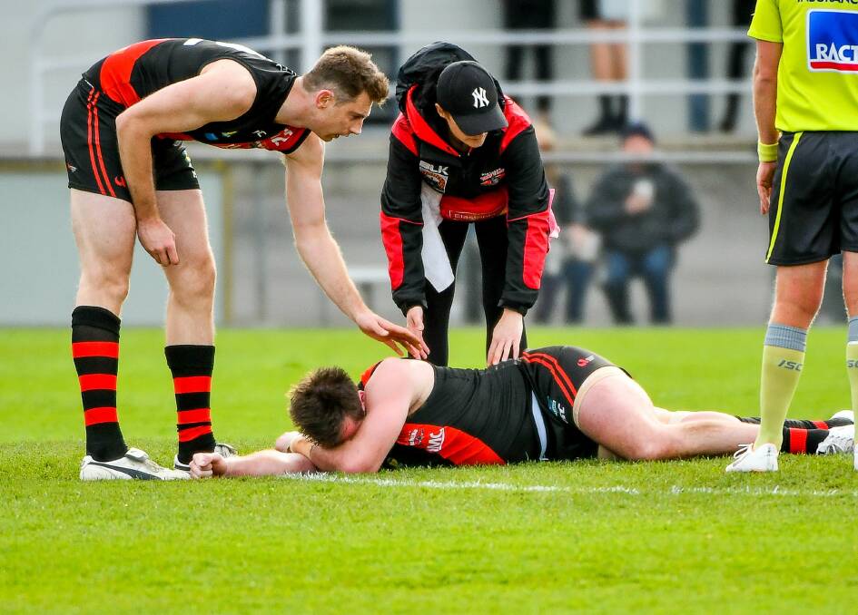 DOWN AND OUT: Alex Lee after collecting his injury against Lauderdale.
Pictures: Scott Gelston