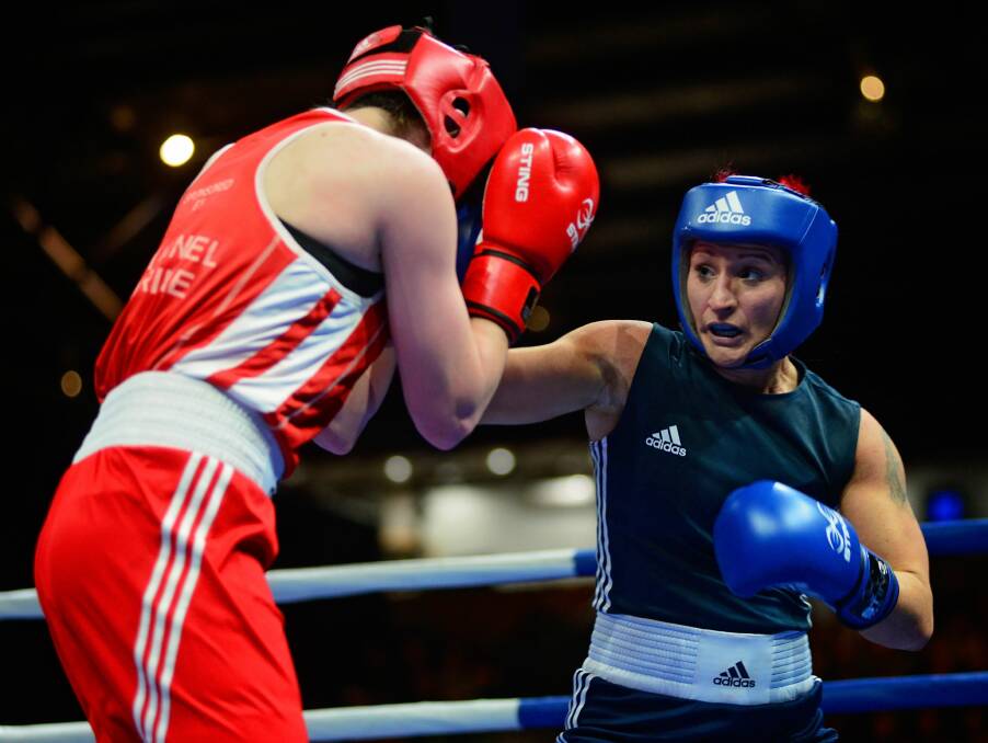 Defence: Georgie Bailey (in red), of the Kingston Boxing Club, against Pamela Mcclelland, of NSW.