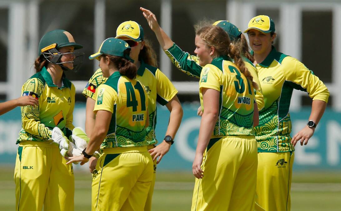 Glove story: Emma Manix-Geeves (left) celebrates a wicket in England with her Australian teammates.
