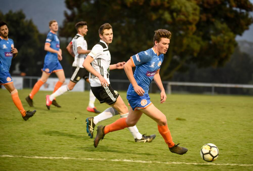 Orange flavour: Riverside defender Will Humphrey advances away from Launceston City striker Noah Mies in last week's NPL Tasmania derby. Picture: Paul Scambler
