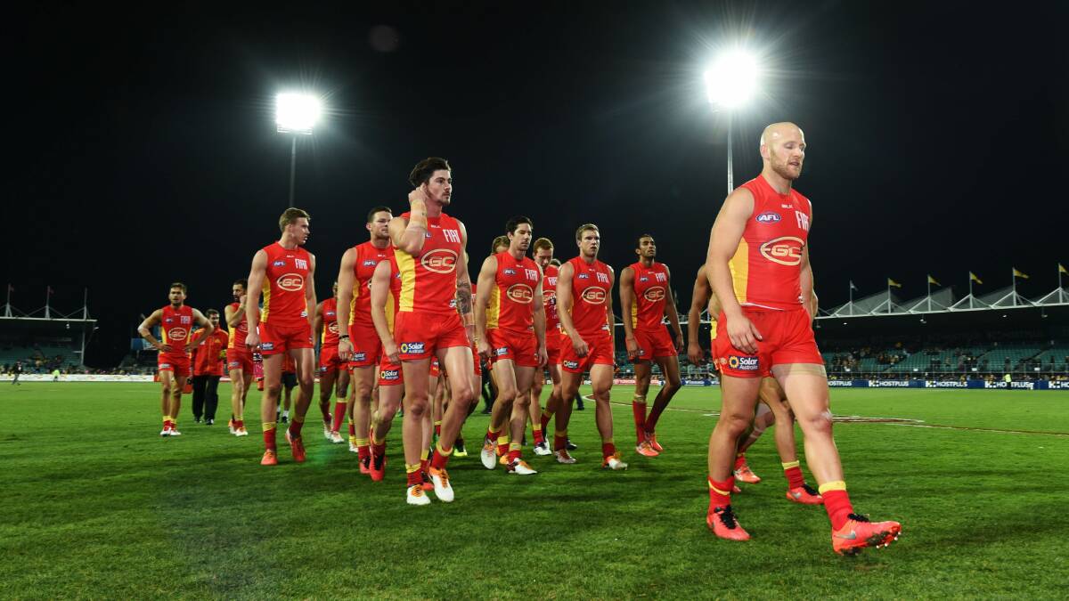 Sun stroke: Gary Ablett and his Gold Coast team leave York Park after being thrashed by Hawthorn in 2016. Picture: Scott Gelston.