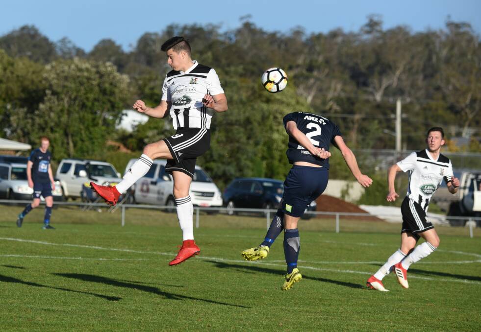 Headless chickens: South Hobart's Connor Schmidt appears to lose his head in an aerial duel with Launceston City's Tyler Fisher.