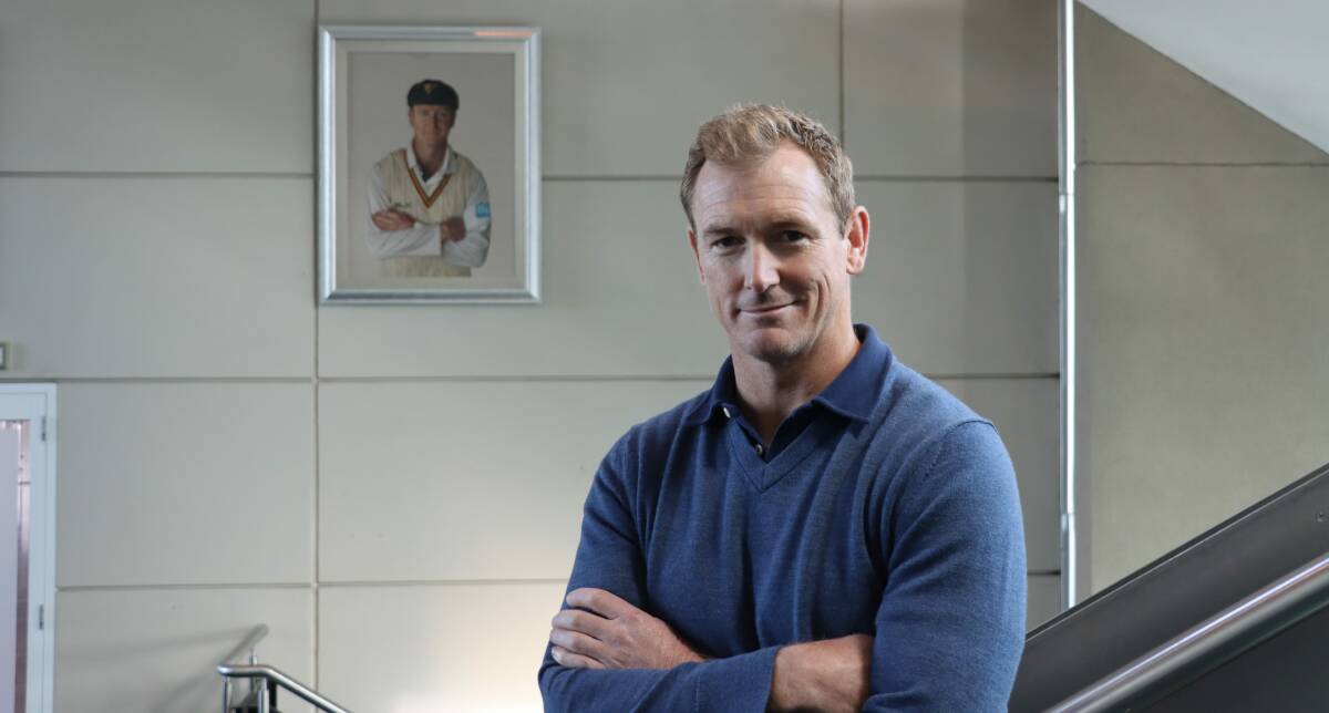 George Bailey by his portrait at Bellerive Oval. Picture by Cricket Tasmania
