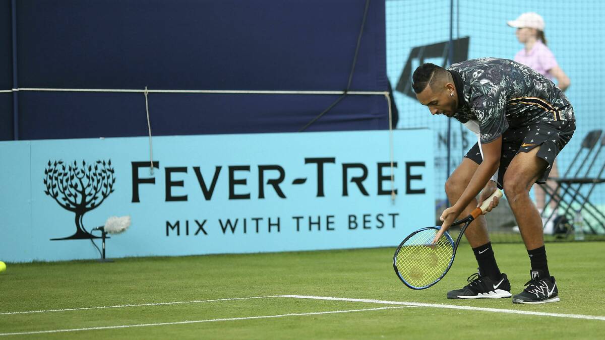 Line call: Australian tennis player Nick Kyrgios invites umpire Fergus Murphy to join him for a rigorous debate about fashion at the Queen's Club in London. Picture: AP