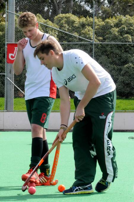 Stepping up: Hayden Beltz, pictured getting some tips from Tasmanian Olympian Eddie Ockenden at a 2012 clinic in Launceston, is now a key member of the state's under-21 side.