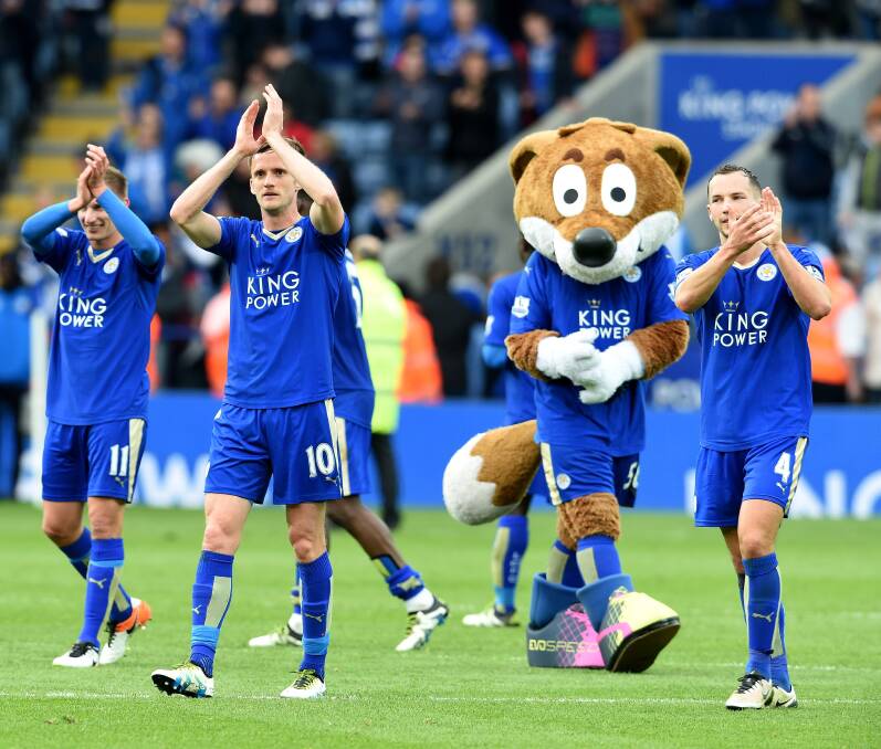 Foxy laddies: Leicester City players, one looking suspiciously like a fox, celebrate after defeating Swansea 4-0 in the English Premier League on Sunday. Picture: Getty Images