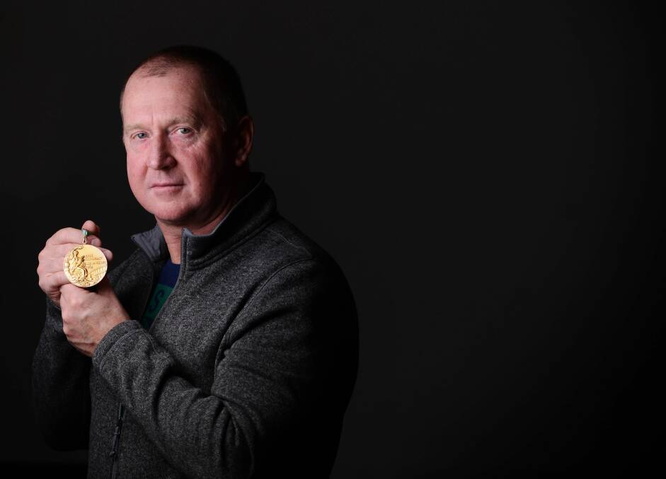Striking gold: Michael Grenda with his Olympic gold medal from 1984. Picture: Scott Gelston