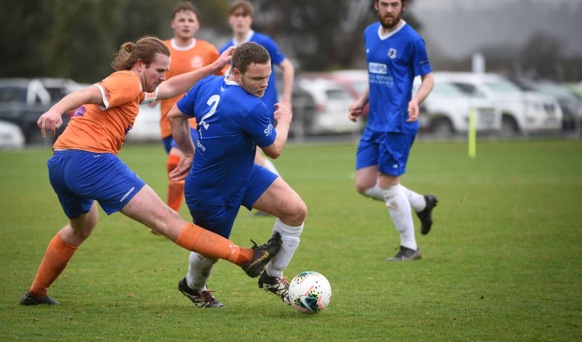 ON THE TURN: Riverside's Drew Sykes tackles Launceston United's Sam Hughes. Picture: Paul Scambler