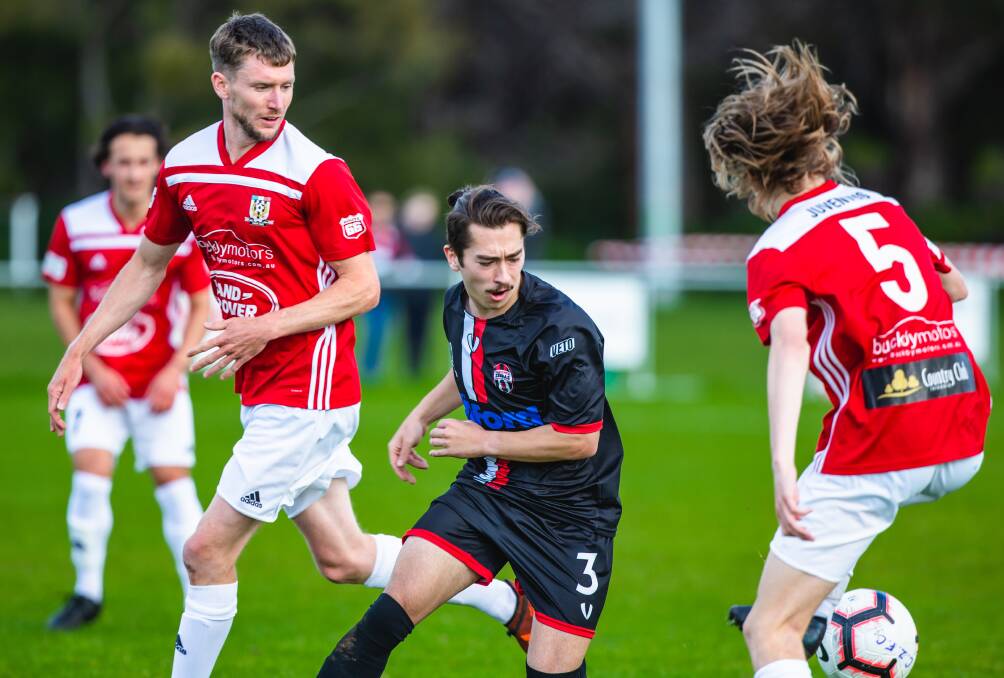 STANDING TALL: Launceston City's Dan Smith keeps an eye on Kane Hatcher, of Clarence. Picture: Solstice Digital