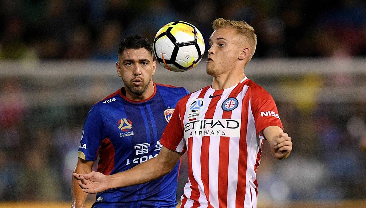 On the ball: Nathaniel Atkinson fends off Dimitri Petratos as Melbourne City take on Newcastle Jets during the A-League semi-final on April 27. Picture: AAP
