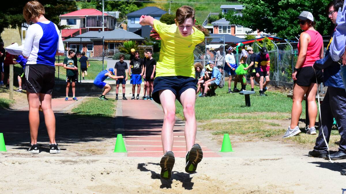 Sand trap: Amos Hurst touches down in the long jump pit.