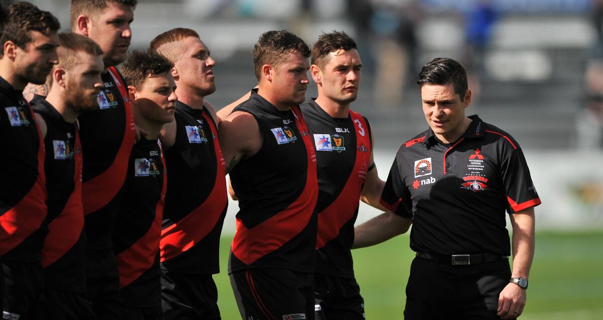 Young and free: Coach Zane Littlejohn joins his North Launceston players for the national anthem before Saturday's State League grand final. Picture: Scott Gelston