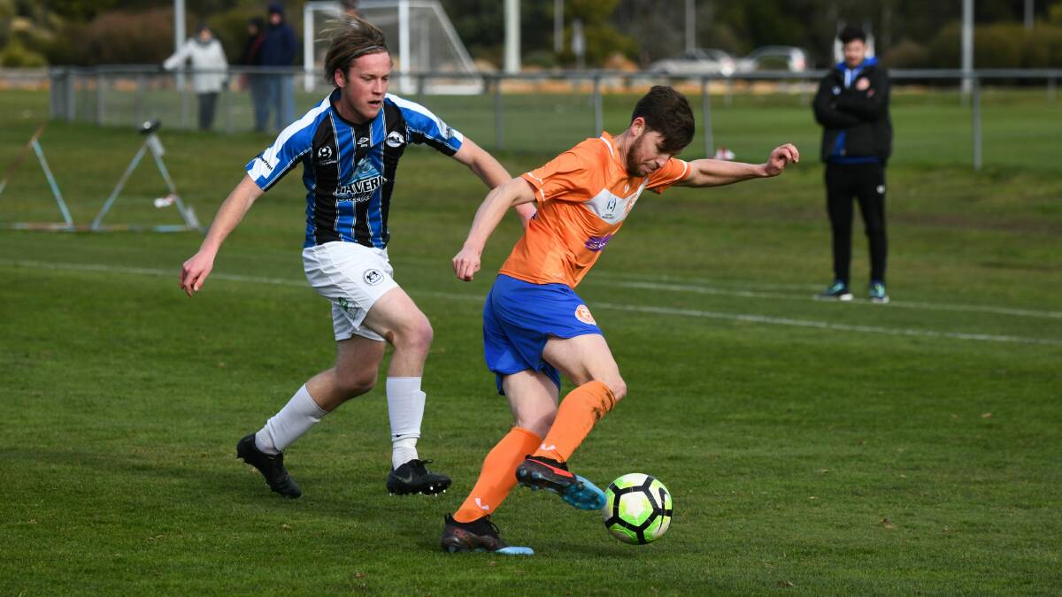 MILESTONE MATCH: Aaron Campbell in action for Riverside against Kingborough, watched by coach Alex Gaetani. Picture: Paul Scambler