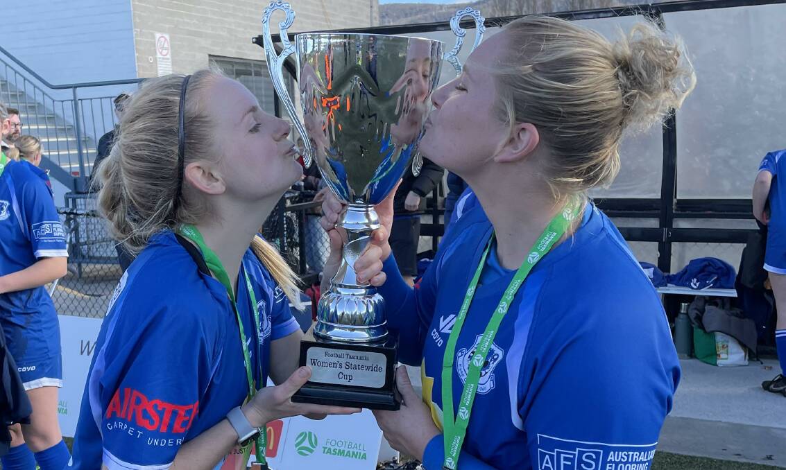CUP AND SORCERER: United imports Alexis Mitchell and Ellie La Monte celebrate with the cup. Picture: Rob Shaw