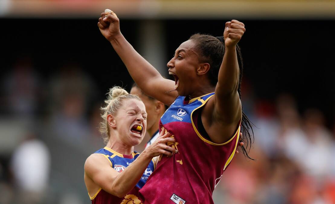 Lions roar: Brisbane players Kate McCarthy and Sabrina Frederick-Traub celebrate during the 2017 AFLW Grand Final against the Adelaide Crows at Metricon Stadium. Picture: Getty Images