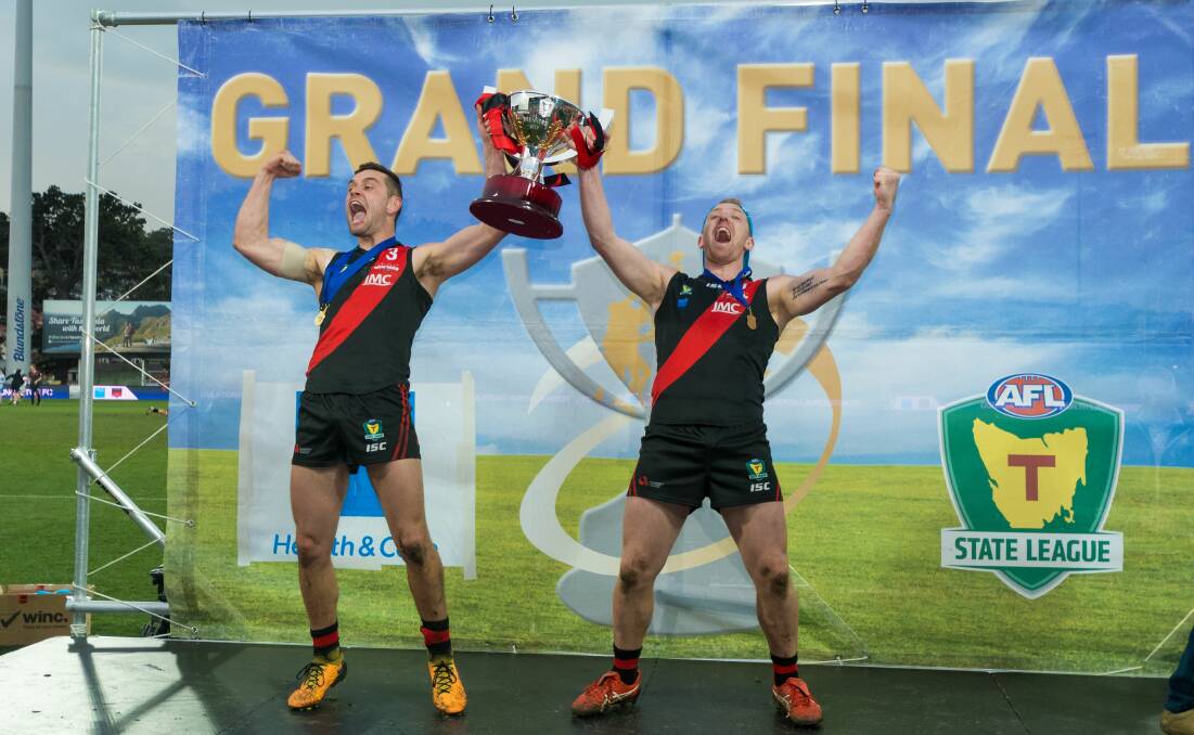 Flag waved: North Launceston's Taylor Whitford and Brad Cox-Goodyer celebrate the 2019 premiership.
