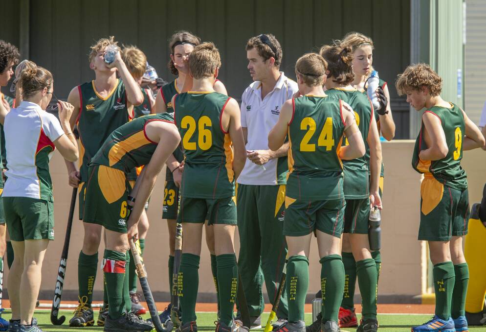 Rest time: The Tasmanian boys team take a breather at the under-15 national hockey championships in NSW. Picture: Click In Focus