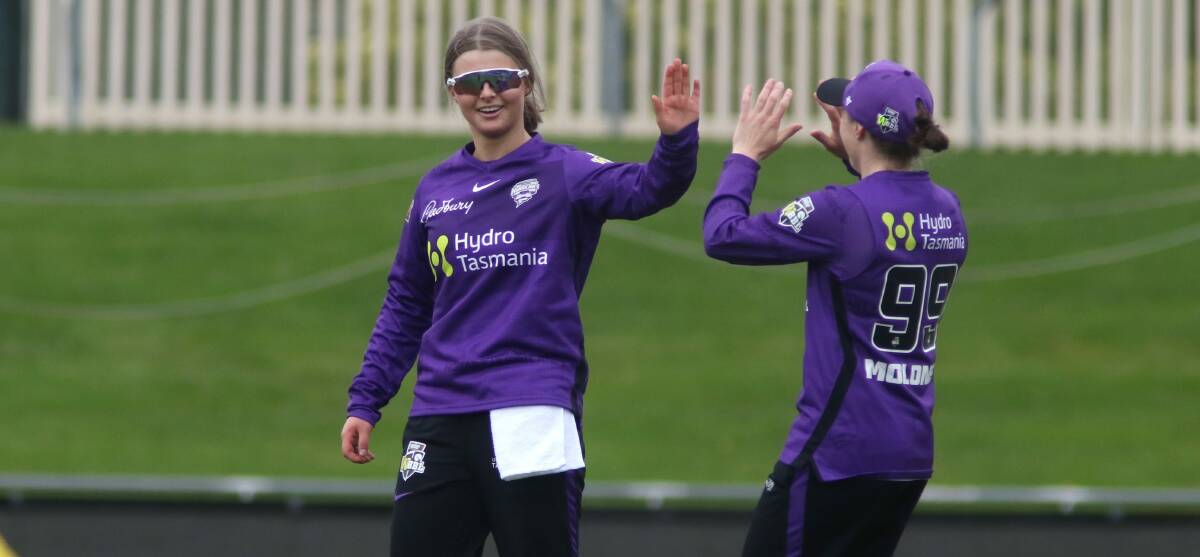 Amy Smith celebrates claiming a wicket with Sasha Moloney.